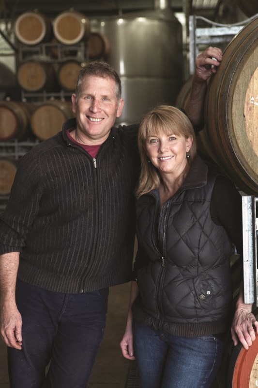 Greg and Kelli in front of Barrels - Greg Cooley Wines